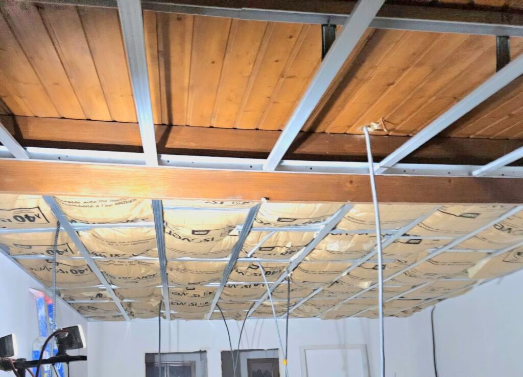 Pose d’un faux plafond avec isolation thermique avant fermeture